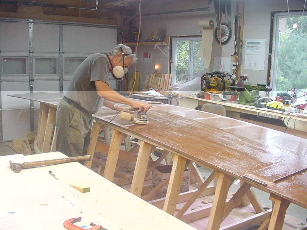 Sanding sides where side frames are glued to plywood.